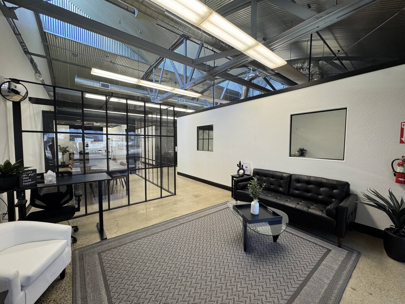 Valley Roots Realty lobby interior — glass-walled conference room and open seating area, 109 S Douty St, Hanford
